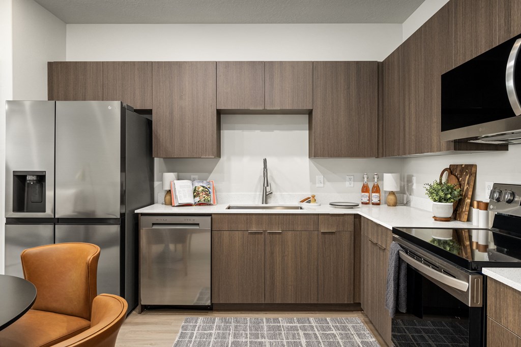 a kitchen with stainless steel appliances and wooden cabinets