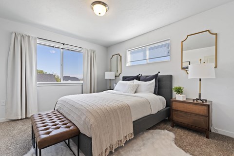 a bedroom with a large bed and a window