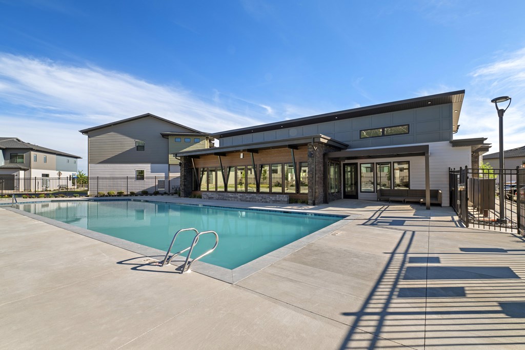 A modern building with a pool in front.