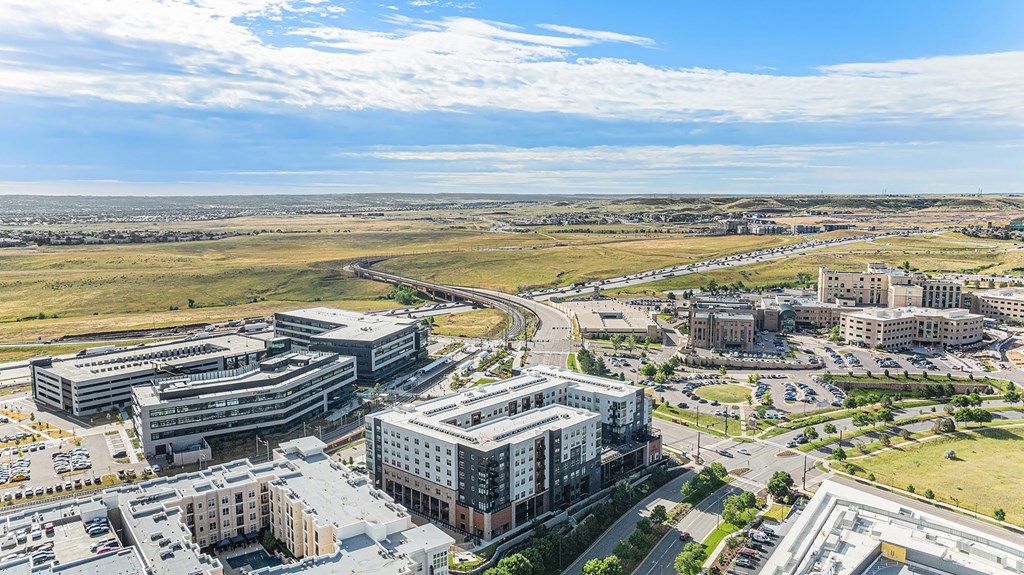 A large, modern building complex sits in the middle of a flat landscape.