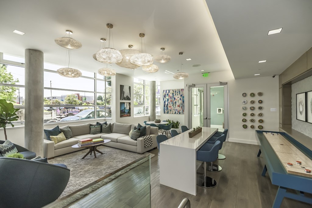 A modern living room with a pool table and a dining table.