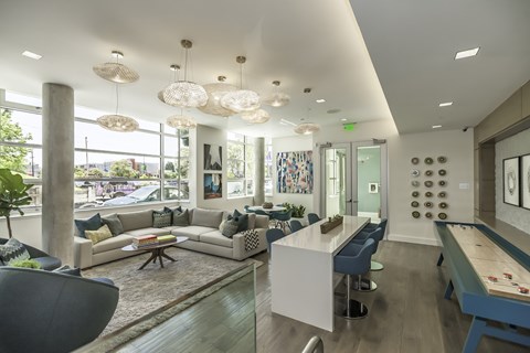 A modern living room with a pool table and a dining table.