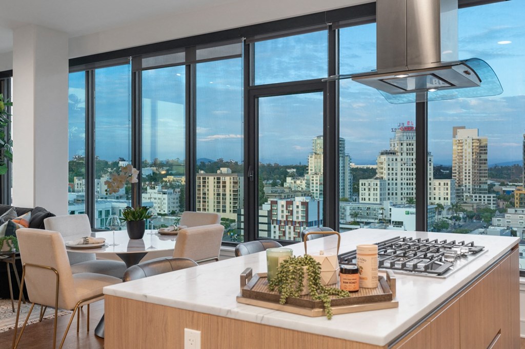 a kitchen with a large island in front of a window with a city view at Stanza Little Italy, California, 92101