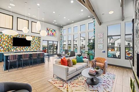A living room with a grey couch and a wooden floor.