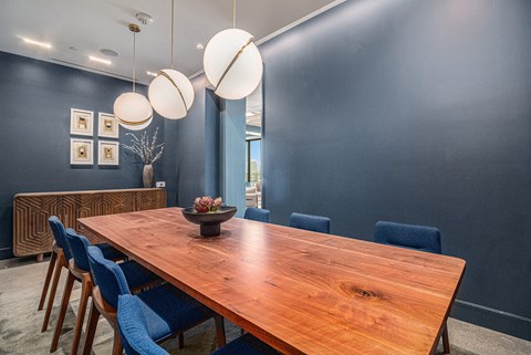 a dining room with a wooden table and blue chairs