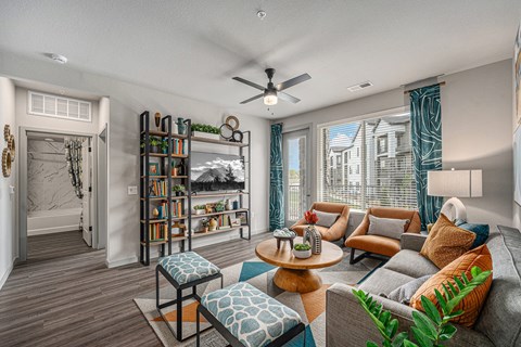 a living room with a couch and a ceiling fan