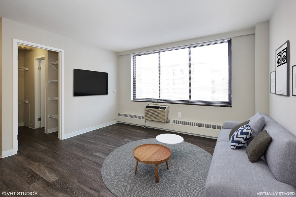 a living room with a gray couch and a round coffee table