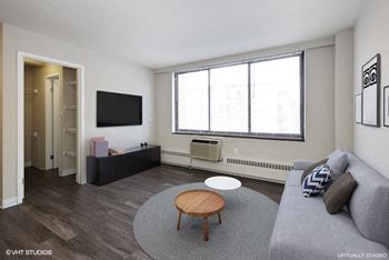 a living room with a gray couch and a coffee table