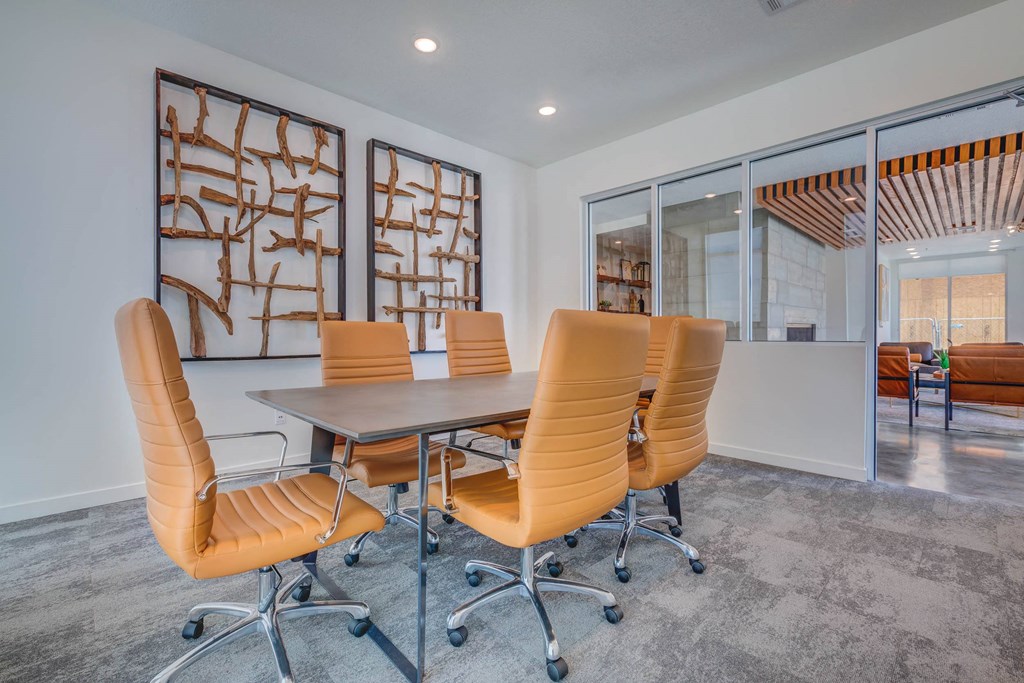 a conference room with white walls and a gray carpeted floor