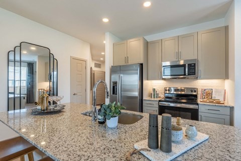 a kitchen with stainless steel appliances and granite counter tops
