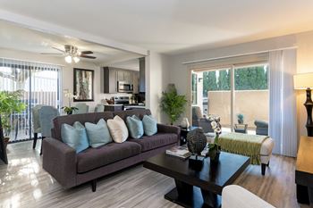 a living room with a couch and a coffee table at The Casas Apartments, California, 92126