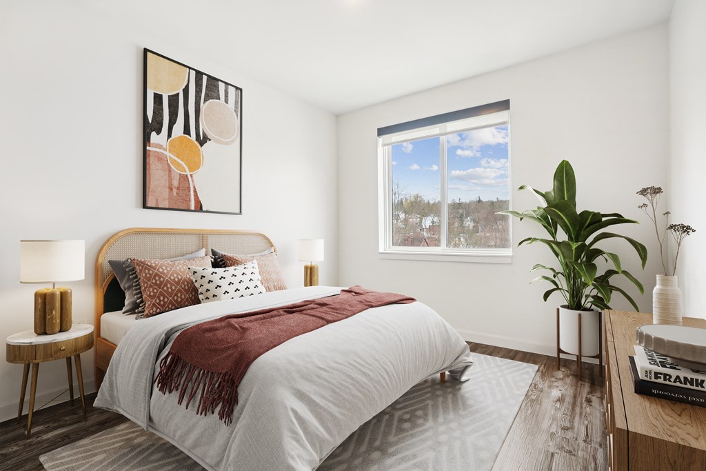 a bedroom with a bed and a window