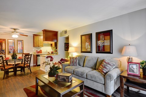 A living room with a grey couch and a coffee table.