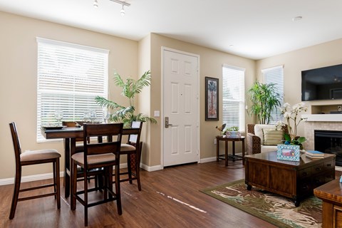 A dining room with a table and chairs.