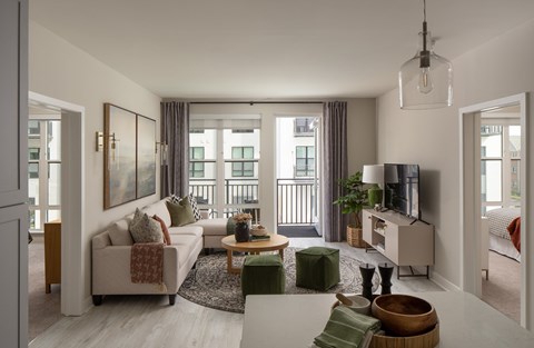 A living room with a white couch and a coffee table.