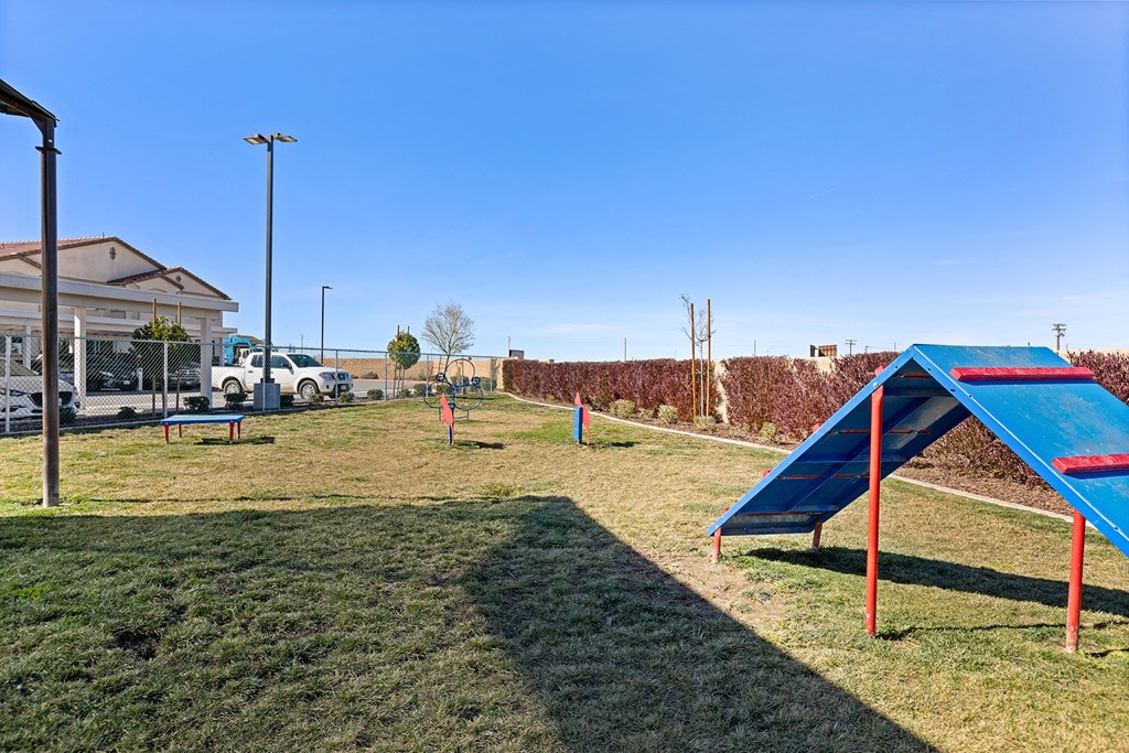 a playground with a slide and a picnic table in a park