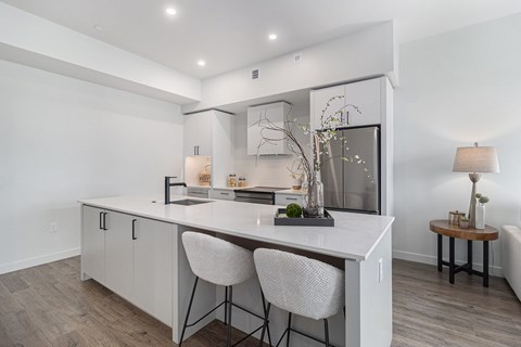 A modern kitchen with a white countertop and a large island.
