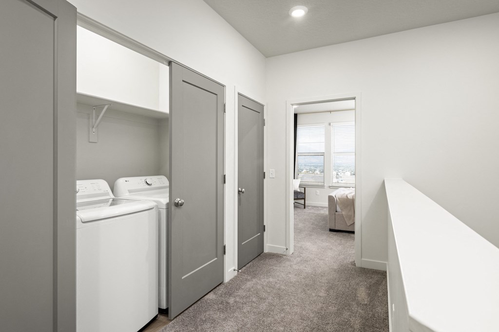 a laundry room with a washer and dryer and a bedroom