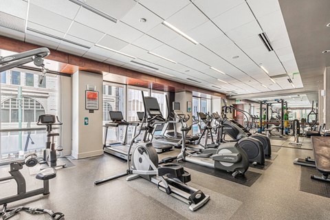 A gym with a variety of exercise equipment including treadmills, stationary bikes, and weight machines. at 1600 Glenarm Place, Denver, CO