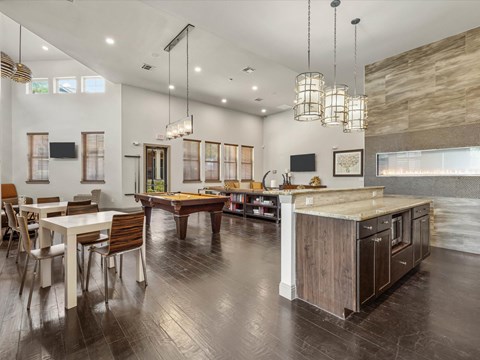 a game room with a pool table and a dining table