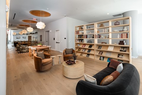 A living room with a bookshelf and a couch.