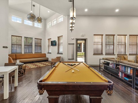 a pool table in the living room of a house