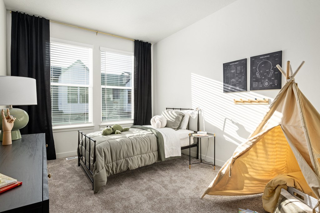 a bedroom with a bed and a tent in the corner
