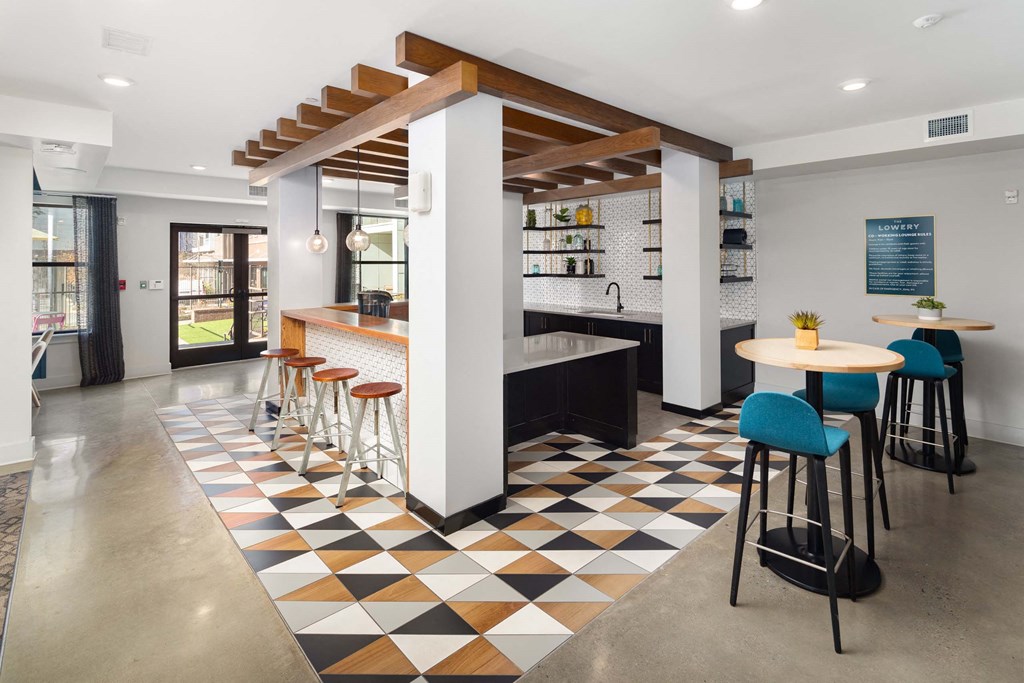 the lobby of a restaurant with a bar and stools