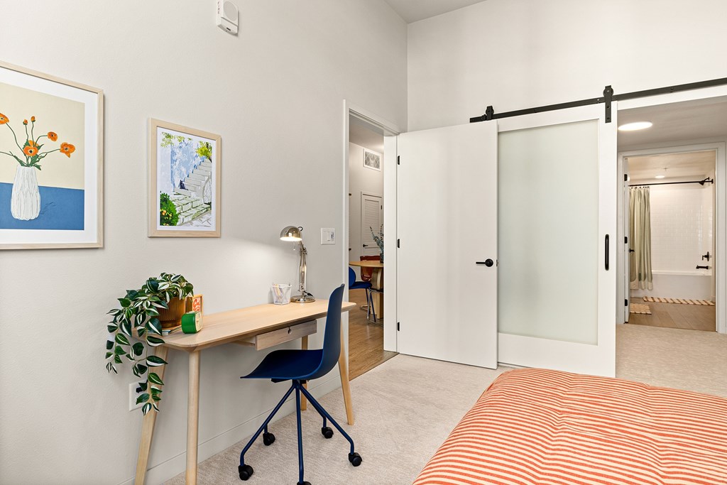 A room with a desk and a chair.