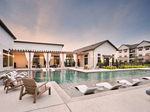 A modern building with a pool in the backyard.