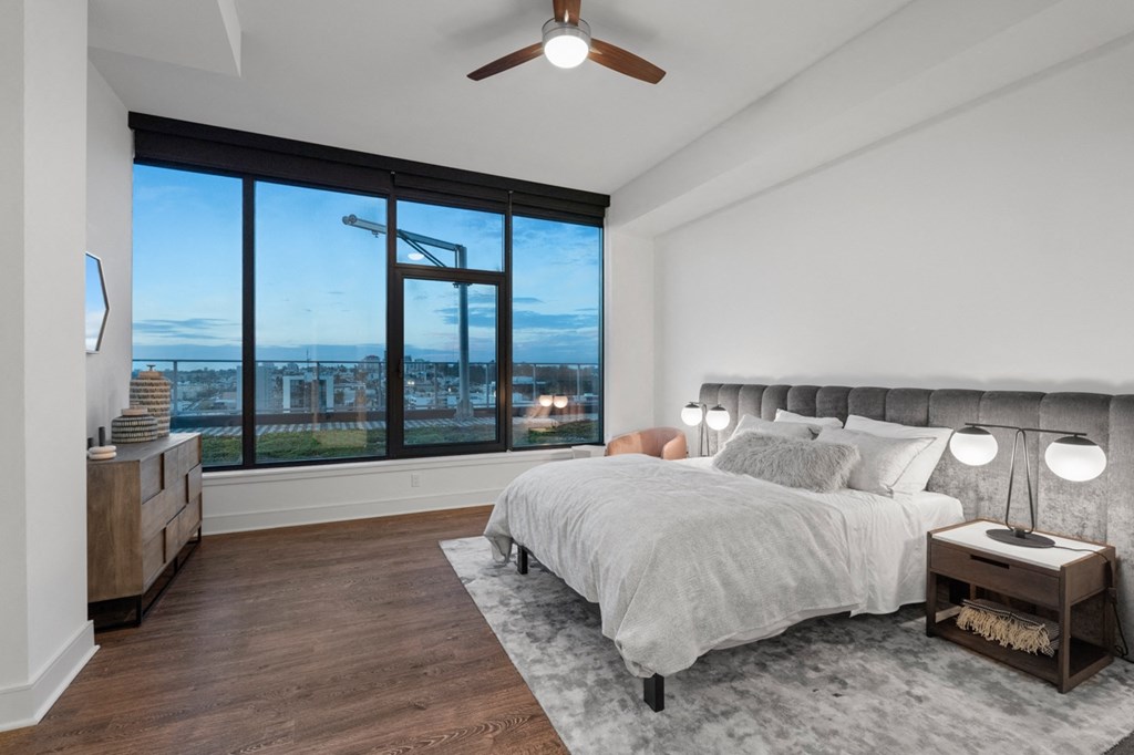 a bedroom with a large bed and a large window at Stanza Little Italy, San Diego, CA