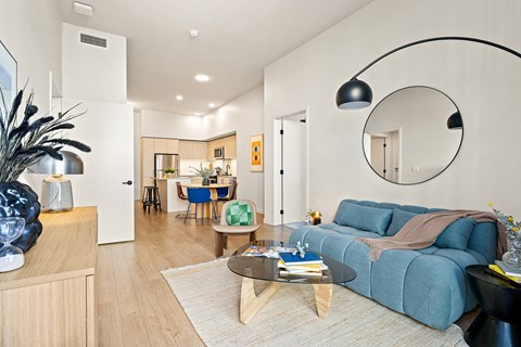 A modern living room with a blue couch and a coffee table.