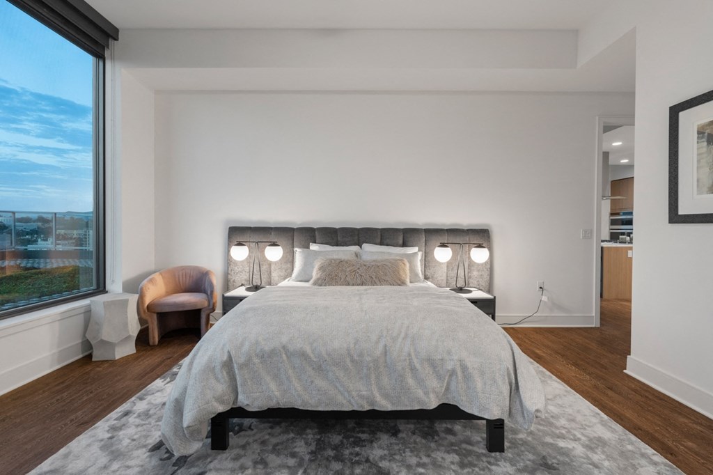 a bedroom with a large bed and a large window  at Stanza Little Italy, San Diego, CA, 92101