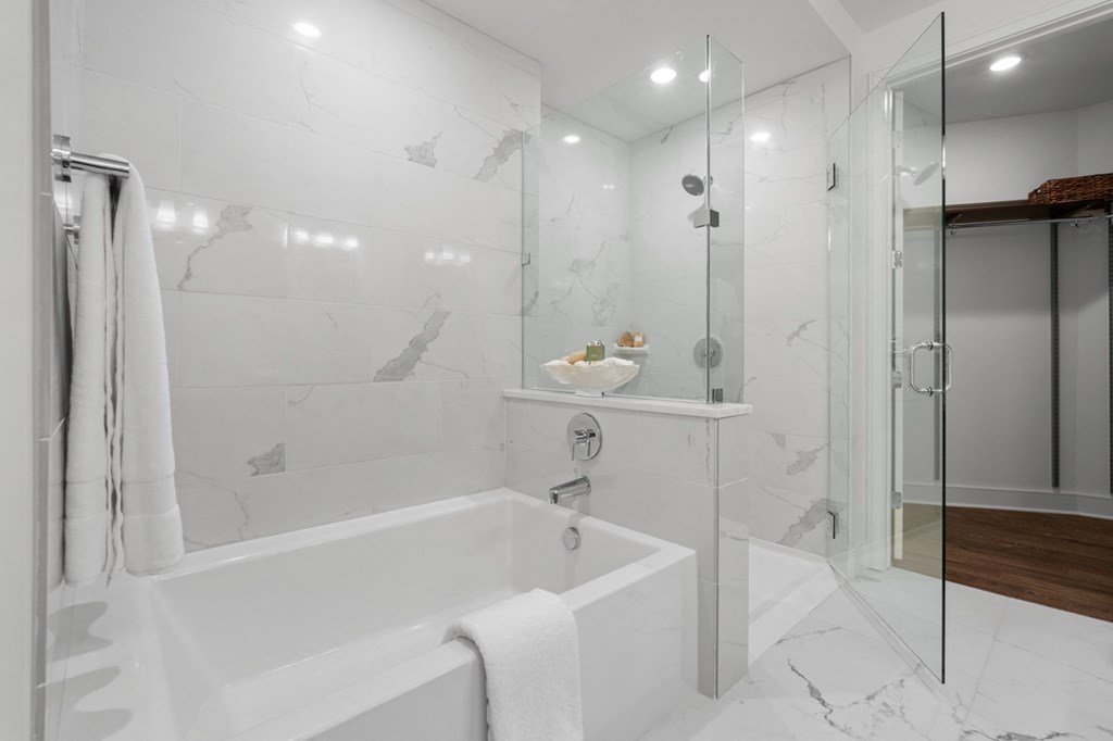 a bathroom with a white bathtub and a glass shower stall at Stanza Little Italy, San Diego, 92101