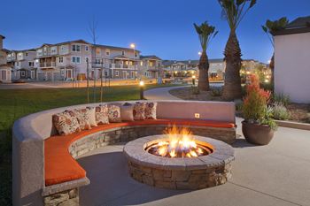 an outdoor fire pit at night in the background