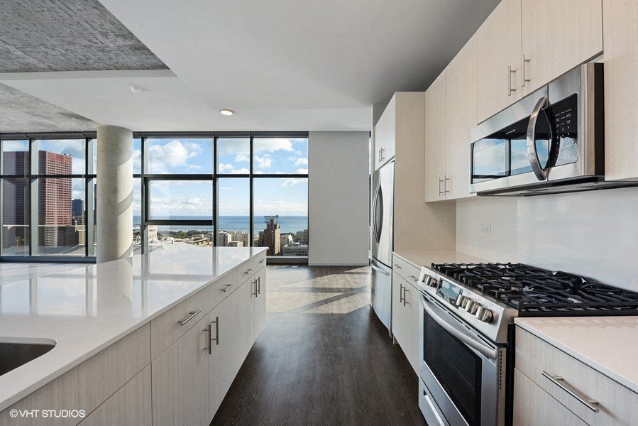 a kitchen with a view of the city and the ocean