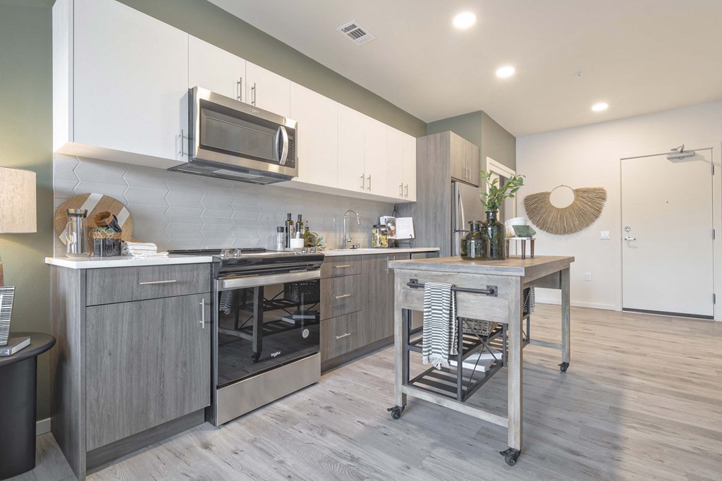 a kitchen with stainless steel appliances and a table