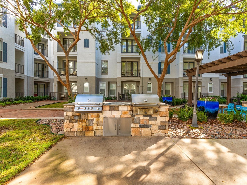 our apartments have a patio with a grill and a barbecue