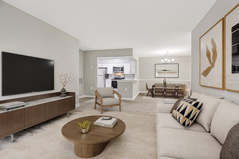 A modern living room with a flat screen TV, a coffee table, and a couch.