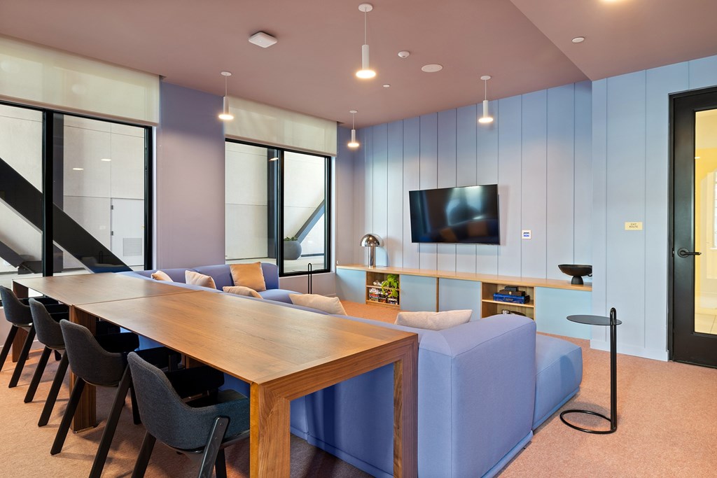 A conference room with a long table and chairs.