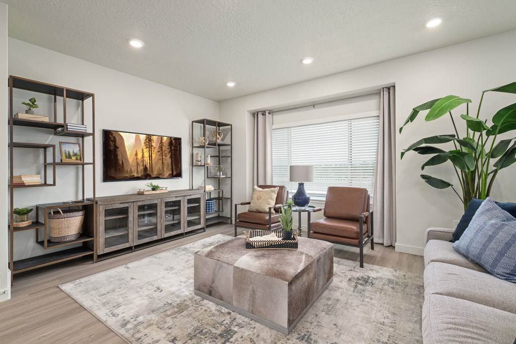 A living room with a brown coffee table and a grey couch.