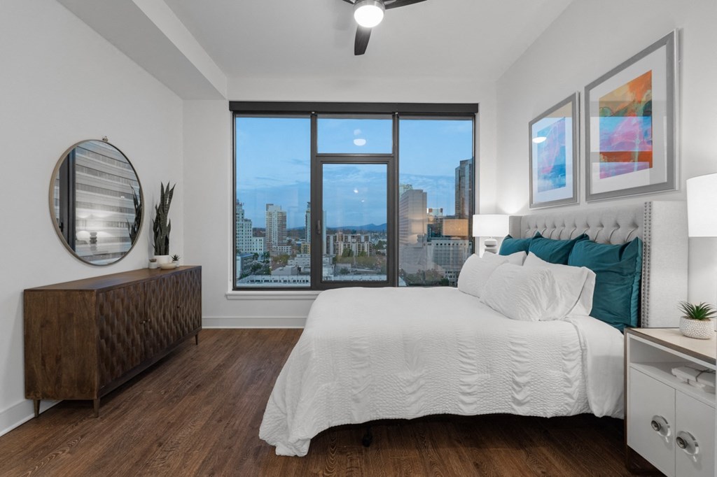 a bedroom with a large bed and a large window at Stanza Little Italy, San Diego, CA, 92101