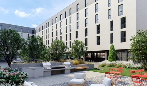 a rendering of a courtyard with a picnic area and barbecue grill in front of a white building