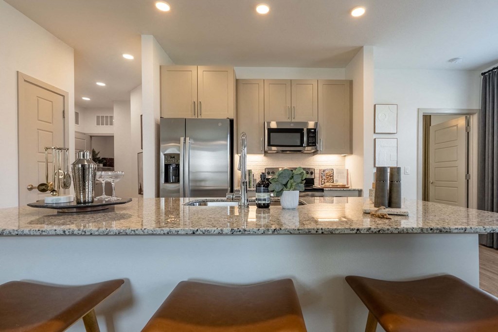 a kitchen with a granite counter top and stainless steel appliances