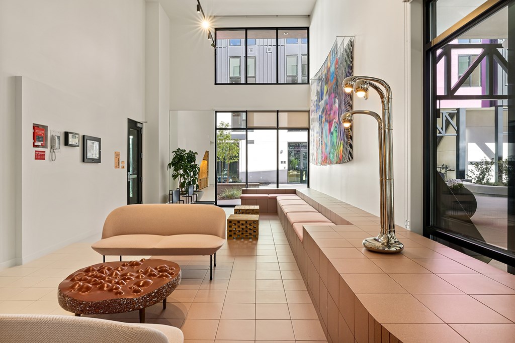 A modern living room with a long bench and a large window.
