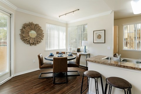 A kitchen with a table and chairs in the middle of the room.