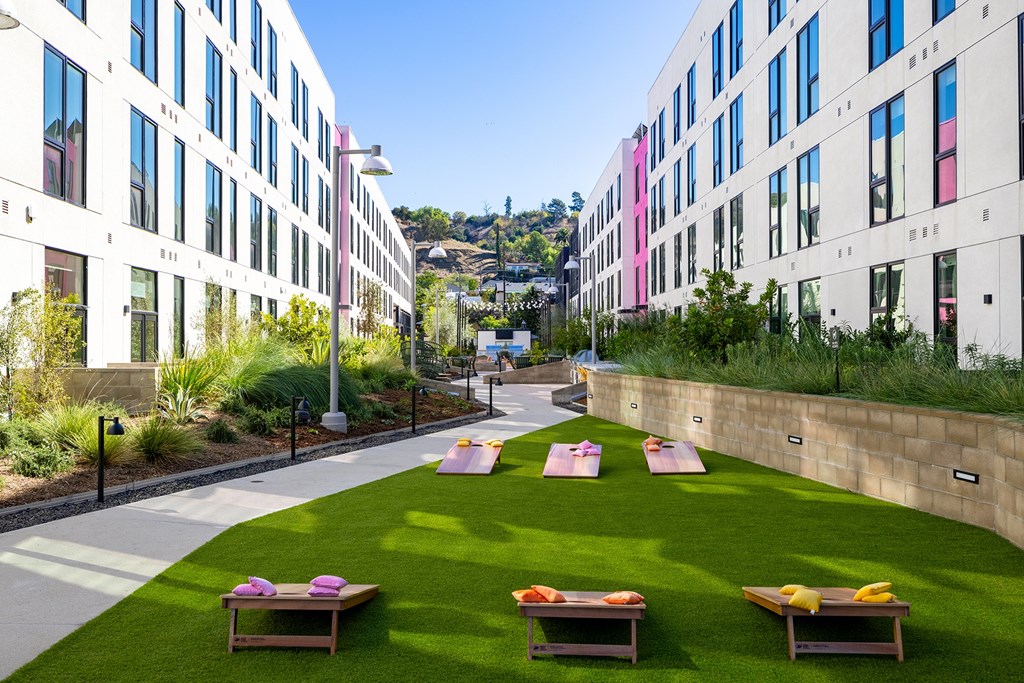 A grassy area with benches in front of a building.