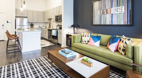 a living room and kitchen with a couch and a coffee table