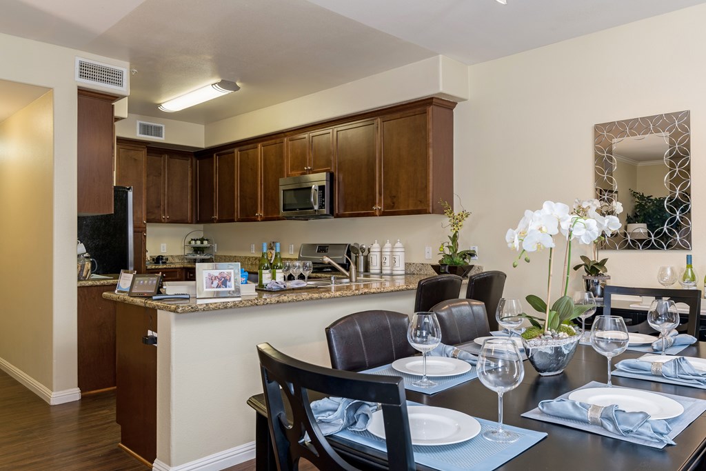A kitchen with a dining table set for two.