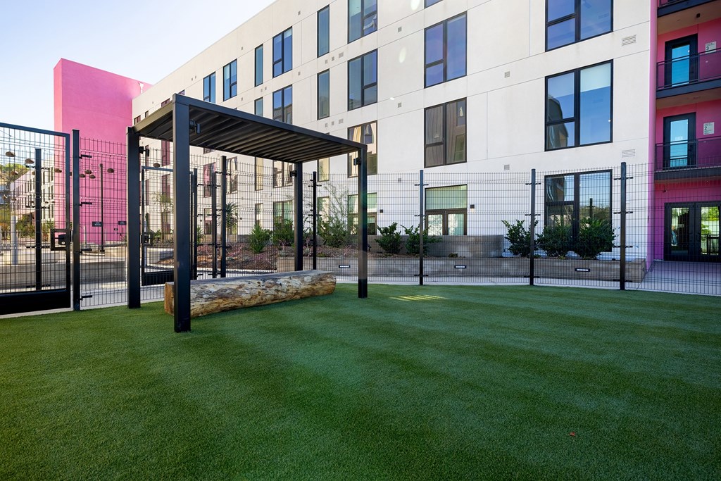 A modern building with a green lawn in front.